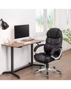 Black high back PU leather office chair beside desk in home office