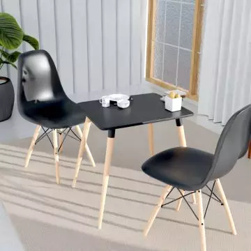 Cenare black dining set with two plastic shell chairs and square table styled in a bright living space with plant and window