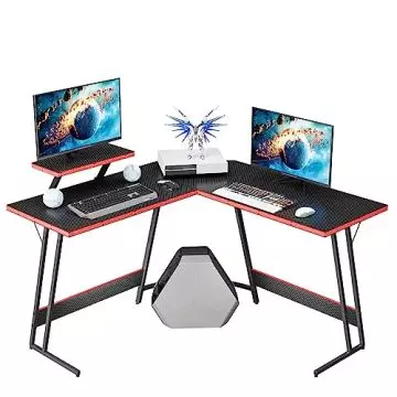 Mahmayi black carbon fiber L-shaped gaming desk with red edge trim monitor riser and dual monitors on white background