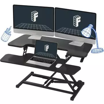 Black two tier sit stand desk riser holding dual monitors and a laptop