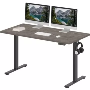 Adjustable standing desk with a dark wood finish  black metal legs  dual monitor setup  keyboard  mouse  and headphone hook.