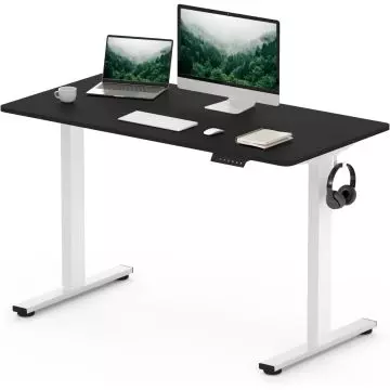 Black and white adjustable standing desk with a laptop  monitor  keyboard  mouse  notebook  cup  and headphones hanging on the side.