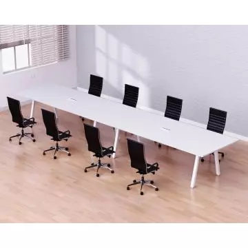Modern conference room with a long white table  eight black leather office chairs  light wood flooring  and white brick walls.