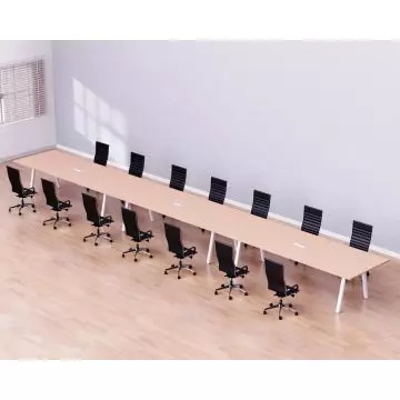 Long conference table with a light wood finish  surrounded by 14 black ergonomic office chairs on a light hardwood floor.