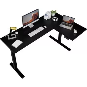 Black L-shaped adjustable standing desk with a monitor  keyboard  laptop  lamp  headphones  books  plant  and cup.