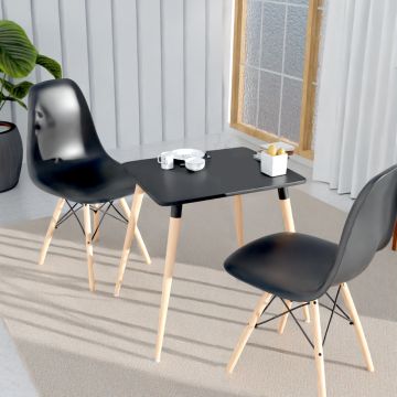 Cenare black dining set with two plastic shell chairs and square table styled in a bright living space with plant and window