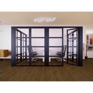 Modern glass-walled office meeting room with black framed door  leather chairs  wooden flooring  and contemporary lighting fixtures.