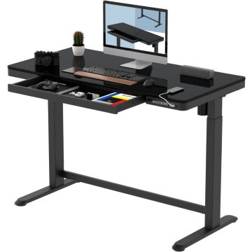 Black adjustable standing desk with built-in drawer  holding computer monitor  keyboard  mouse  camera  phone  and small potted plant.