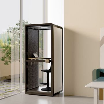 Single person phone pod with glass door by window