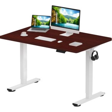 Adjustable standing desk with white legs  a dark wood top  and a headphone hook  featuring a computer  laptop  keyboard  mouse  and a coffee cup.