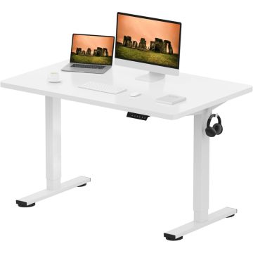 White adjustable standing desk with a laptop  monitor  keyboard  mouse  notebook  coffee cup  and black headphones hanging on the side.