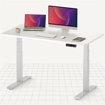 White electric standing desk with laptop and monitor