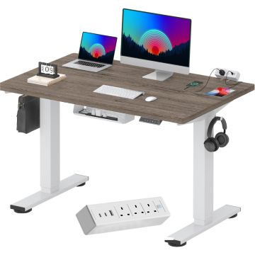 White frame standing desk with gray woodgrain top and tabletop power strip