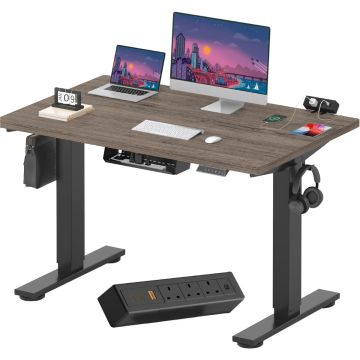Electric standing desk with gray woodgrain top black frame cable tray and clamp power strip