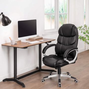 Black high back PU leather office chair beside desk in home office