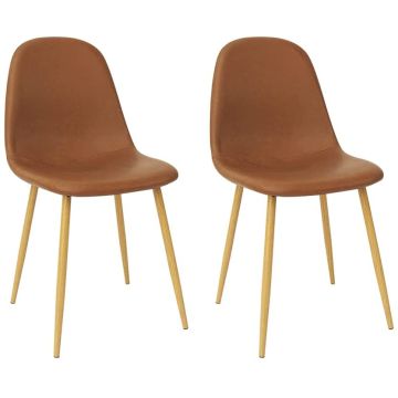 Brown PU dining chairs styled beside a round black marble dining table in a modern interior