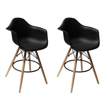 Set of 2 black Eames style DAW bar stools with natural wood legs and black metal footrest ring shown at angle