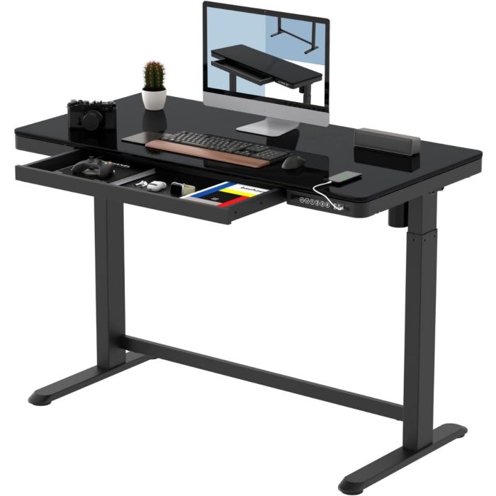 Black adjustable standing desk with a glass top  built-in drawer  and digital control panel  featuring a computer monitor  keyboard  and accessories.