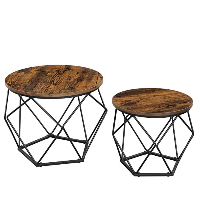 Two round rustic brown tables with black geometric bases